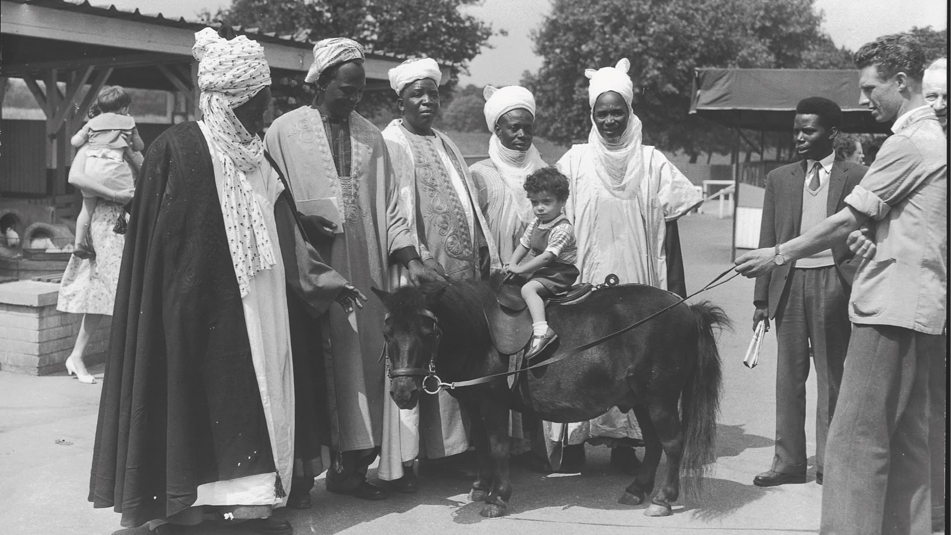 A picture of five emirs from Nigeria with a child on a donkey at London Zoo, on a trip to Britain.